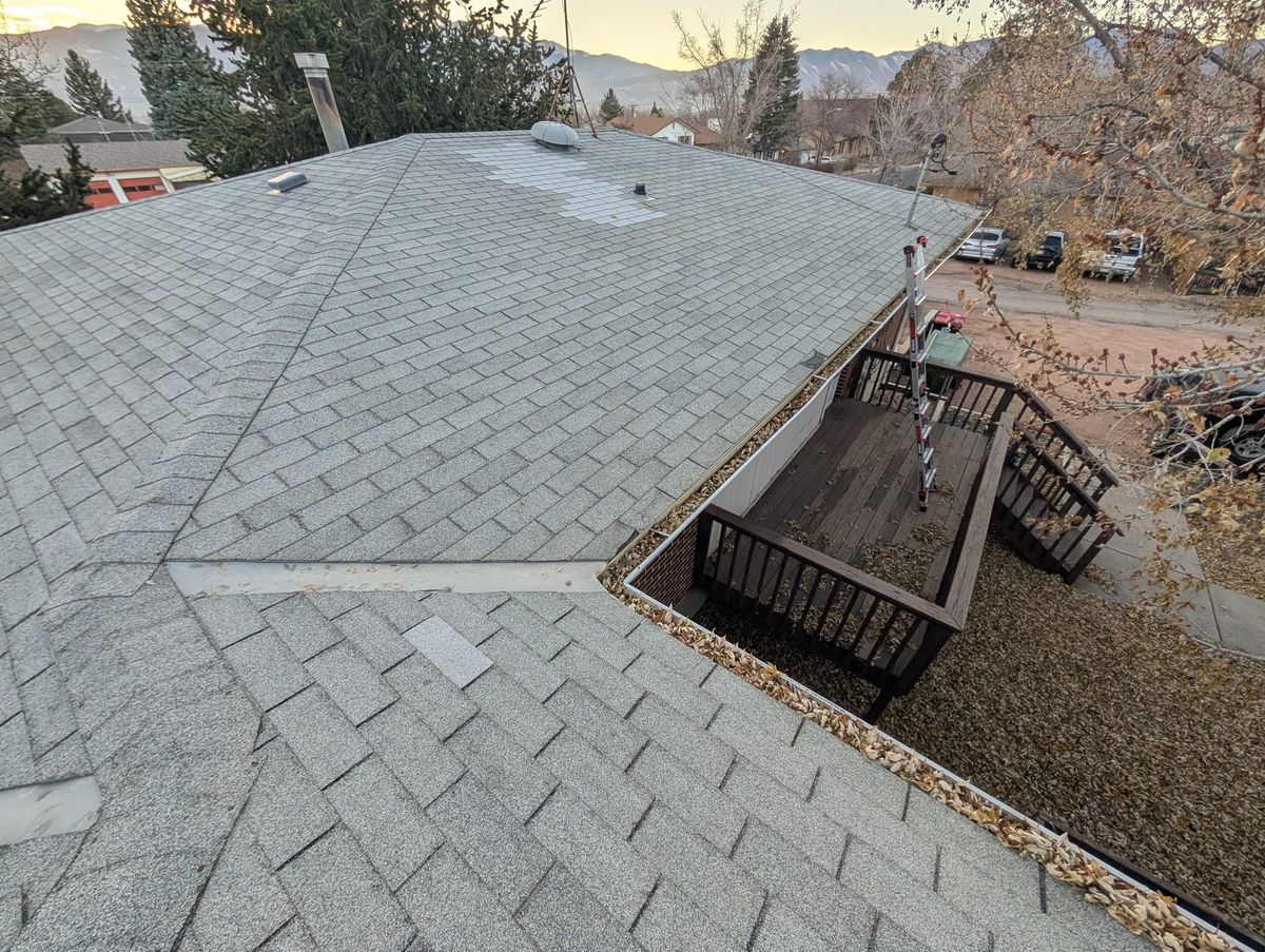 Old shingle roof at 1312 Acacia Drive, Colorado Springs showing storm wear before replacement