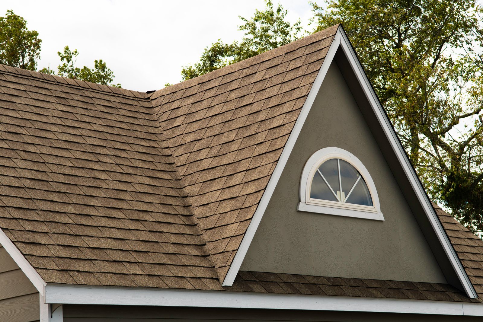 Detail of a shingle roof gable with dormer window on a Colorado Springs home by Fixins