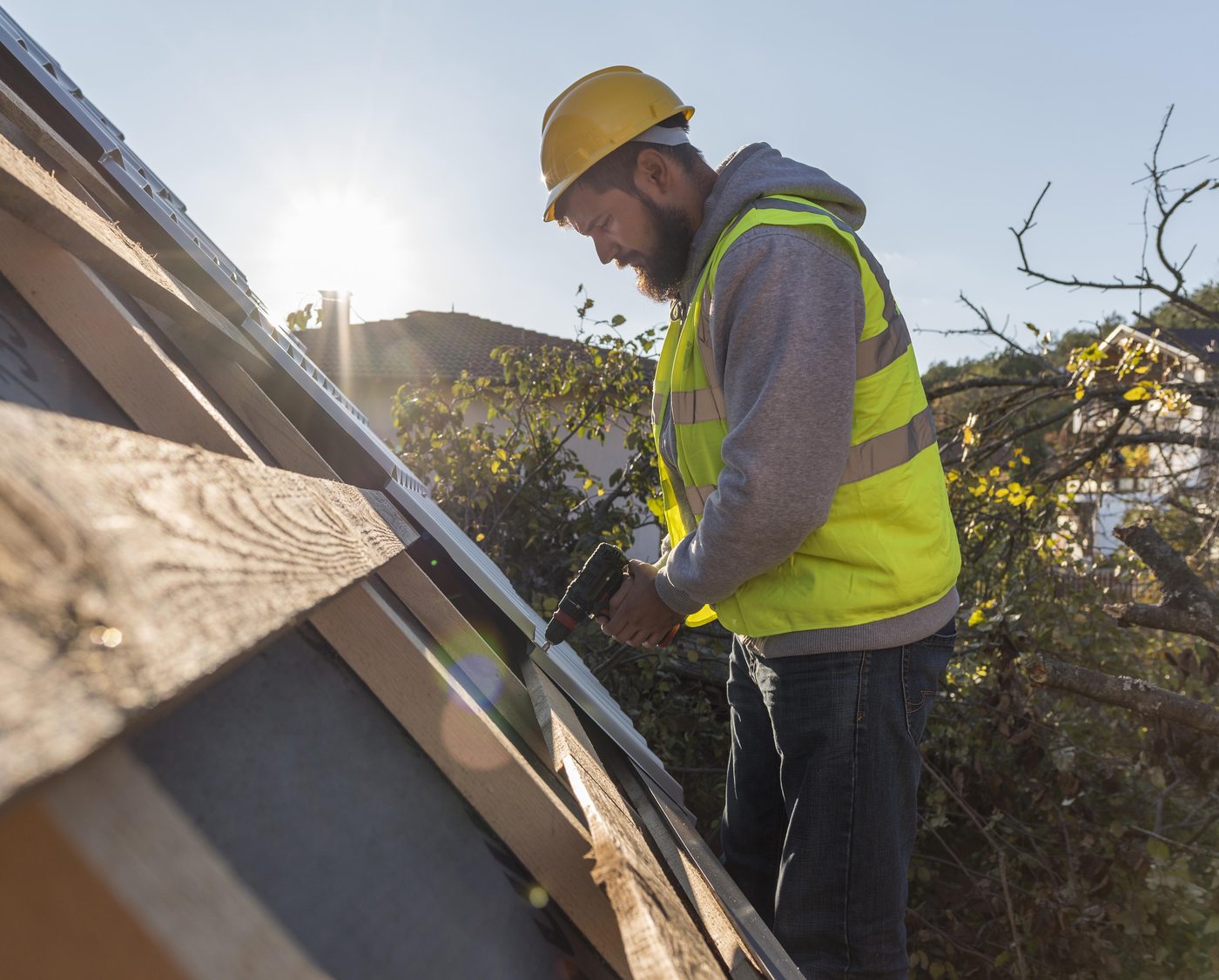 Fixins roofer securing a storm-damaged roof edge in Colorado Springs